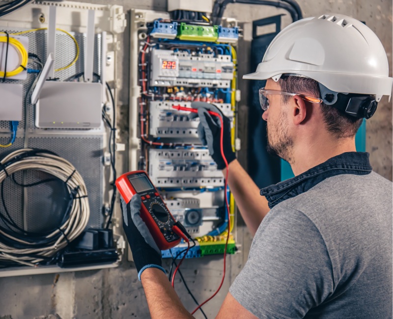 man-electrical-technician-working-switchboard-with-fuses-1